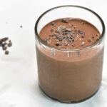 Cold brew smoothie with cacao nibs scattered on the sides