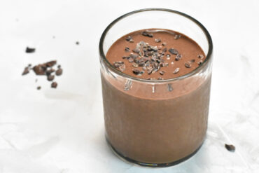 Cold brew smoothie with cacao nibs scattered on the sides