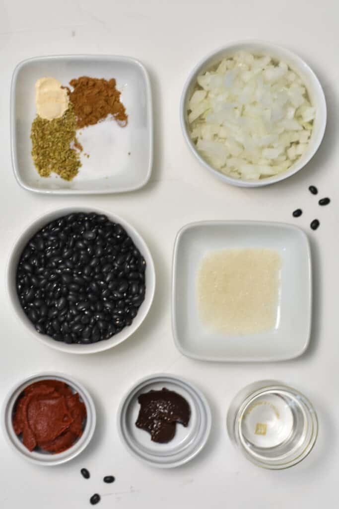 ingredients for cuban black beans laid out in white bowls