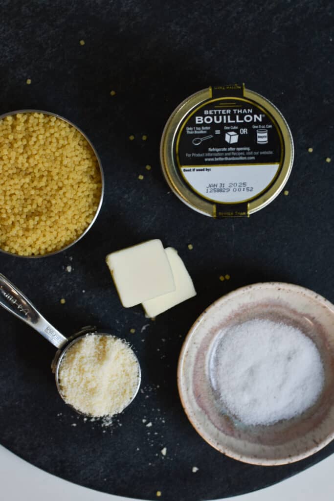 Ingredients for Comforting and Classic Pastina laid out on black cutting board