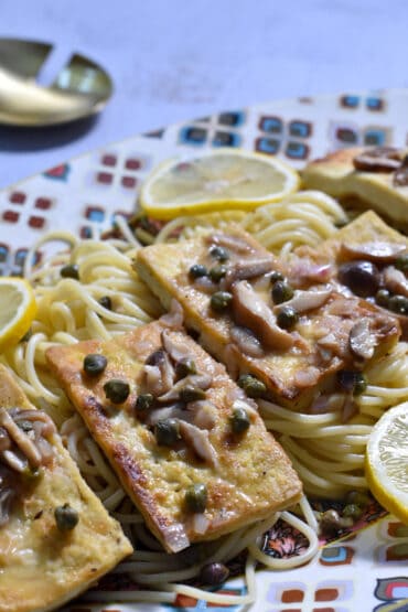 Tofu Piccata on a platter of spaghetti