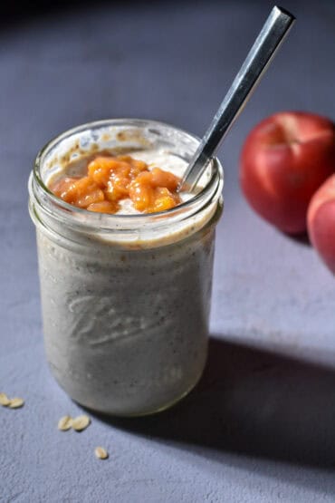 Peach Pie Overnight oats in a mason jar with peaches in the