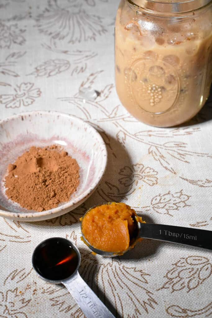 Easy Pumpkin Iced Coffee ingredients, maple syrup, canned pumpkin and pumpkin pie spices.
