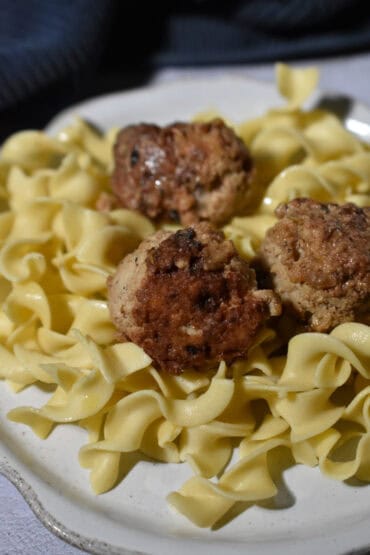 Easy Pan-Fried Turkey Meatballs with Creamy Pan Sauce over egg noodles