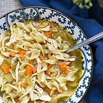 Homemade chicken noodle soup with shredded chicken, carrots, celery and egg noodles topped with freshly cracked black pepper.