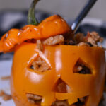 Halloween stuffed peppers carved into jack-o’-lanterns and filled with ground turkey, rice, black beans, and cheese