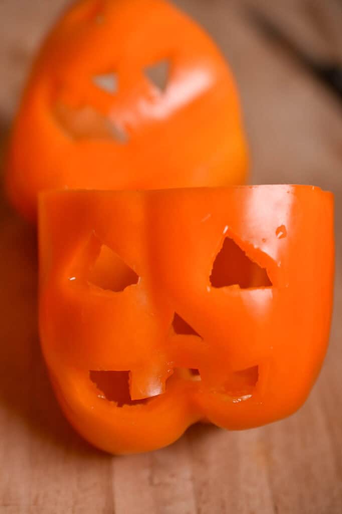 Cut peppers in the shape of jack o lanterns
