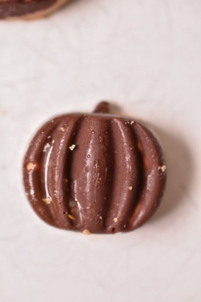frozen chocolate peanut butter banana bites in a pumpkin shape